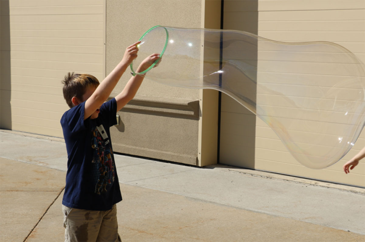 Child blowing bubbles.