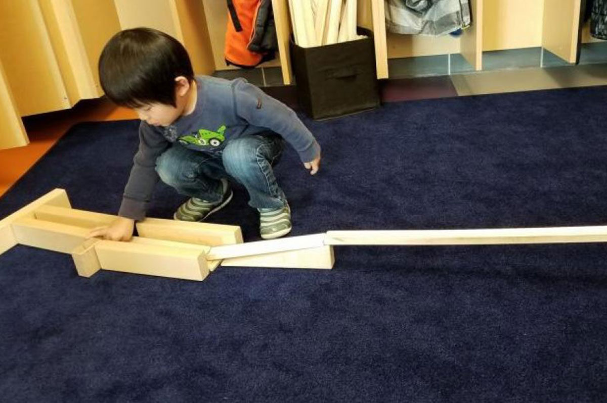 Child playing with ramps.