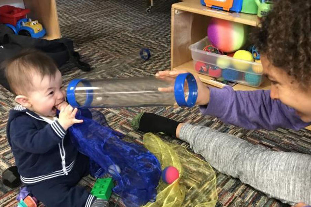 Child playing with tubes.