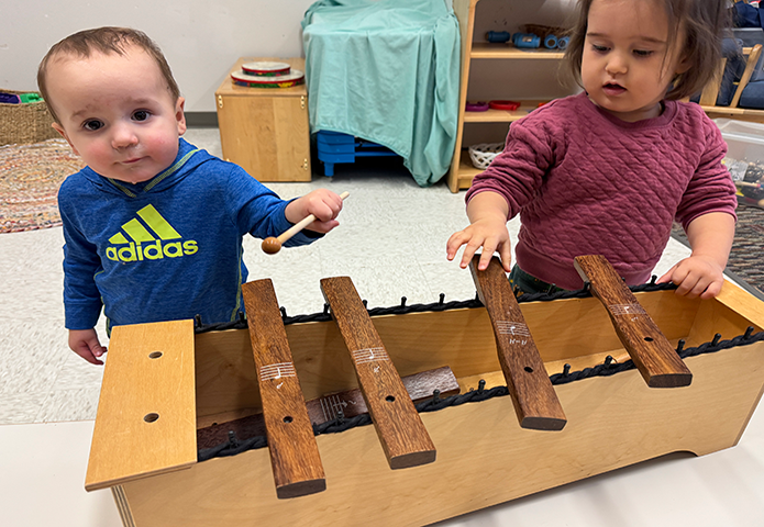 Toddlers making sound on a xylophone