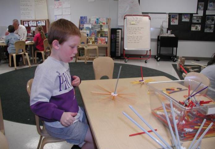 Child creating a toy.