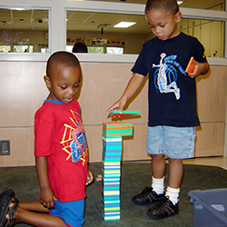 Two boys playing with blocks.