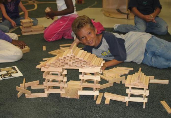 Student laying down next to objects.