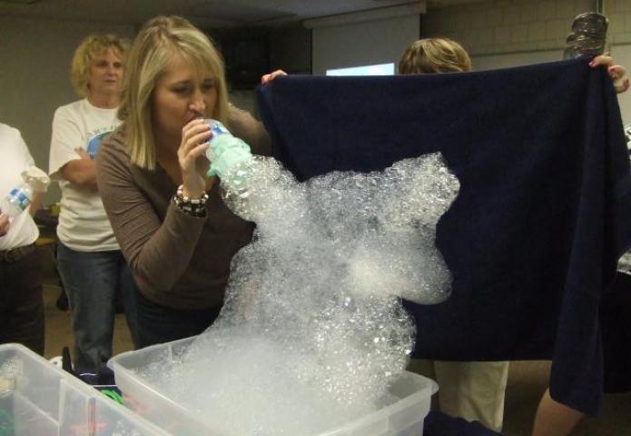 Teacher blowing bubbles.