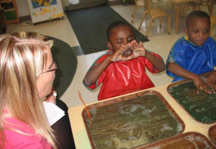 Blowing bubbles out of a tray.