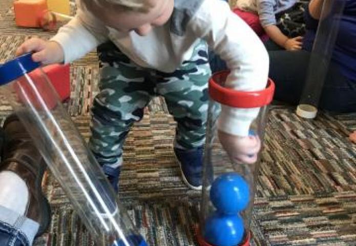 Placing blue balls in a tube.