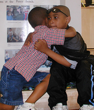 Two kids hugging.