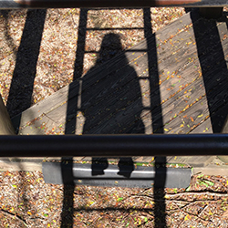 Child sitting on a ladder.