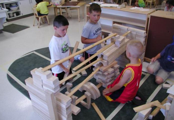 3 boys playing with multiple ramps.