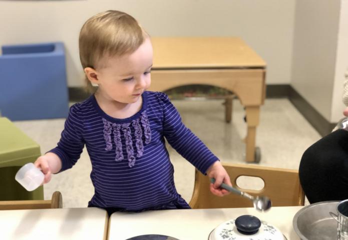 Child playing with pots.