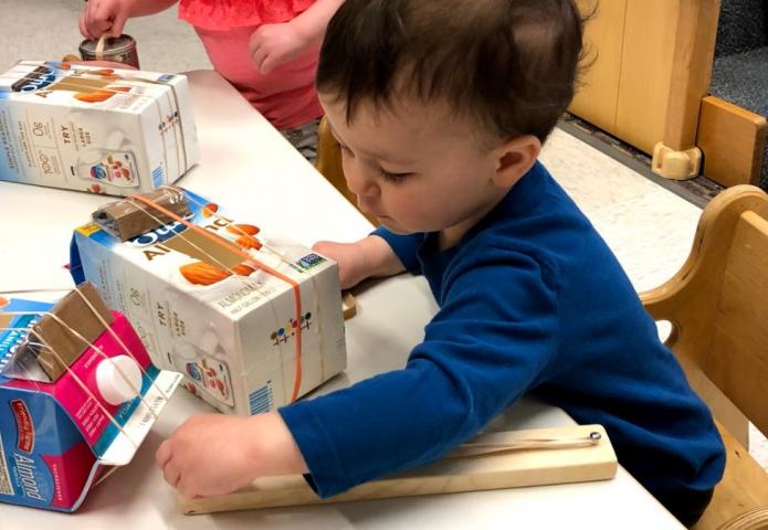 Child playing with a juice carton.