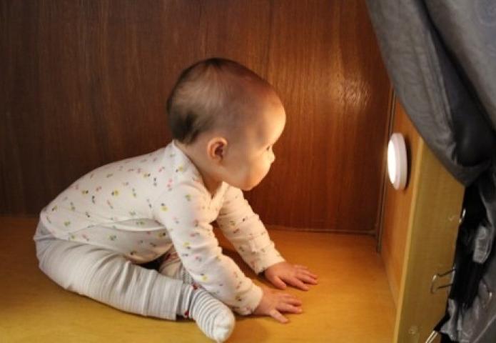 Infant staring at a lamp.