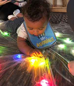 Infant playing with lights.