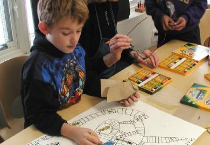 Student with a large board doing math problems.