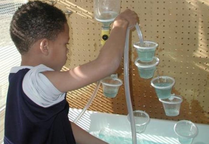 Child filling cups.