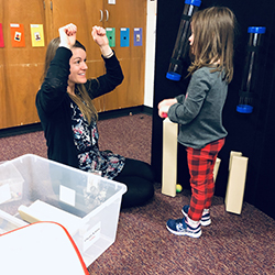 Teacher playing with a small child.