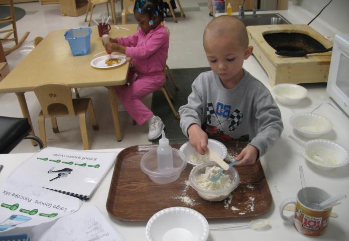 Mixing pancakes on a tray.