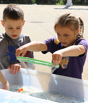 Kids playing with ziplock bags.