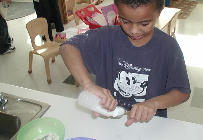 Child mixing dough.