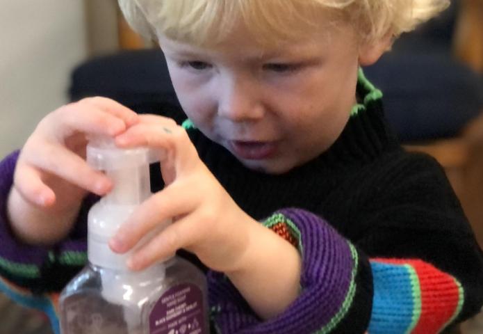 Child using a soap pump.