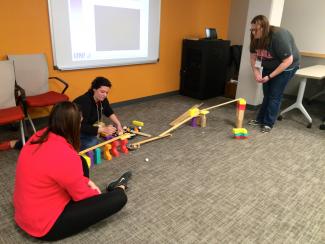 Educators playing with ramps.