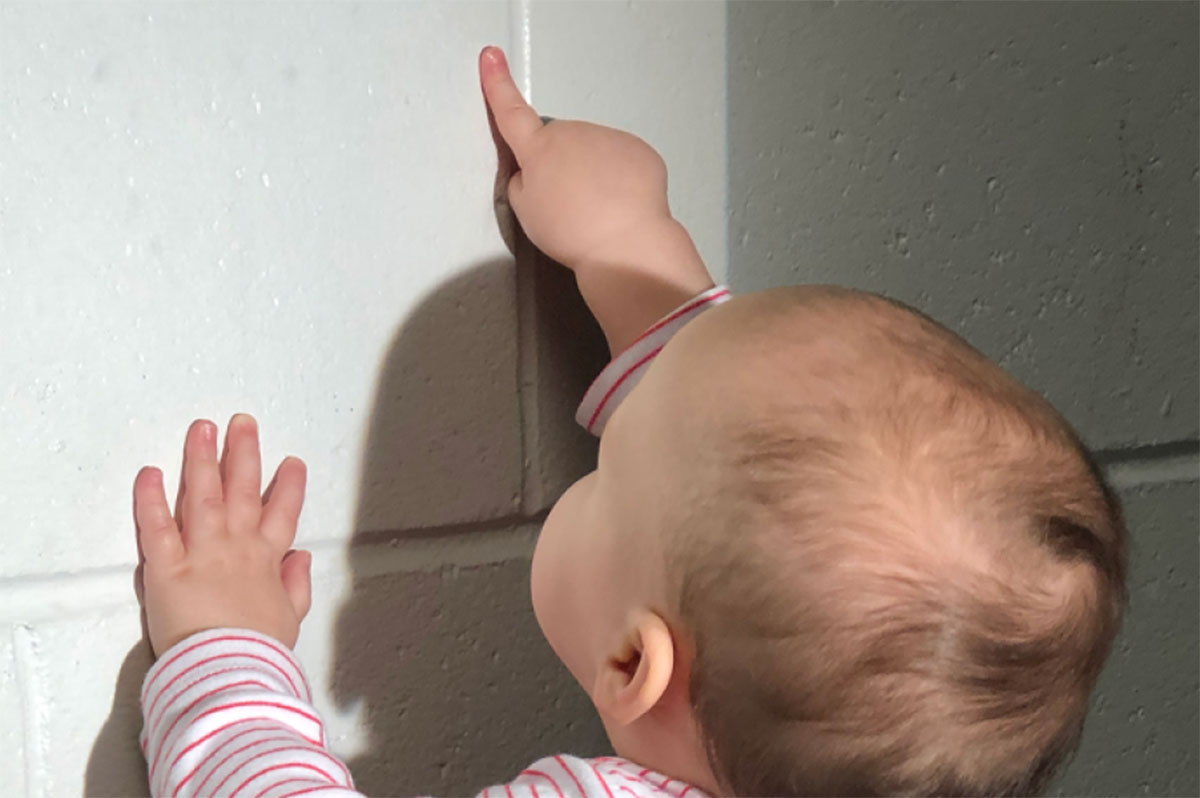 Baby pointing to the wall