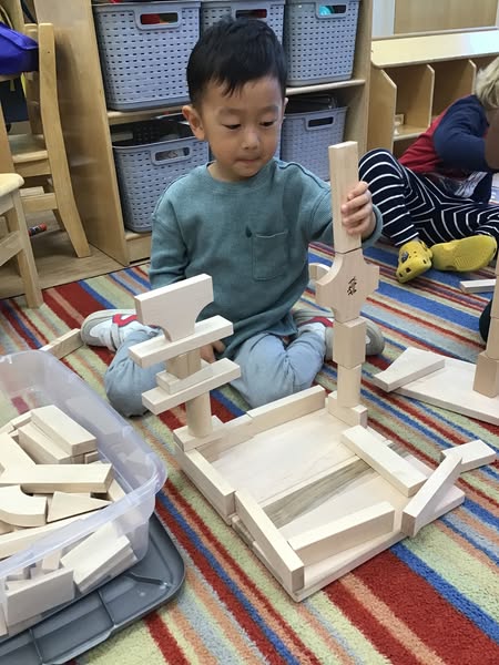 Young boy building with blocks