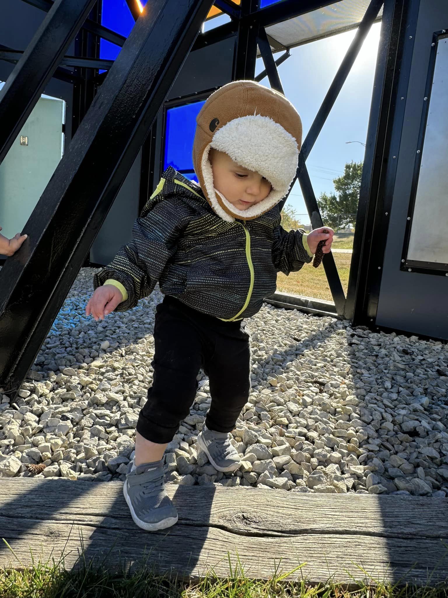 toddler trying balance himself on board