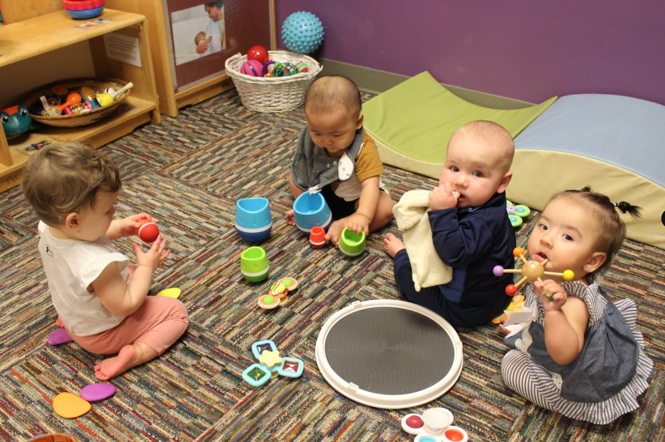 infants playing with materials that spin