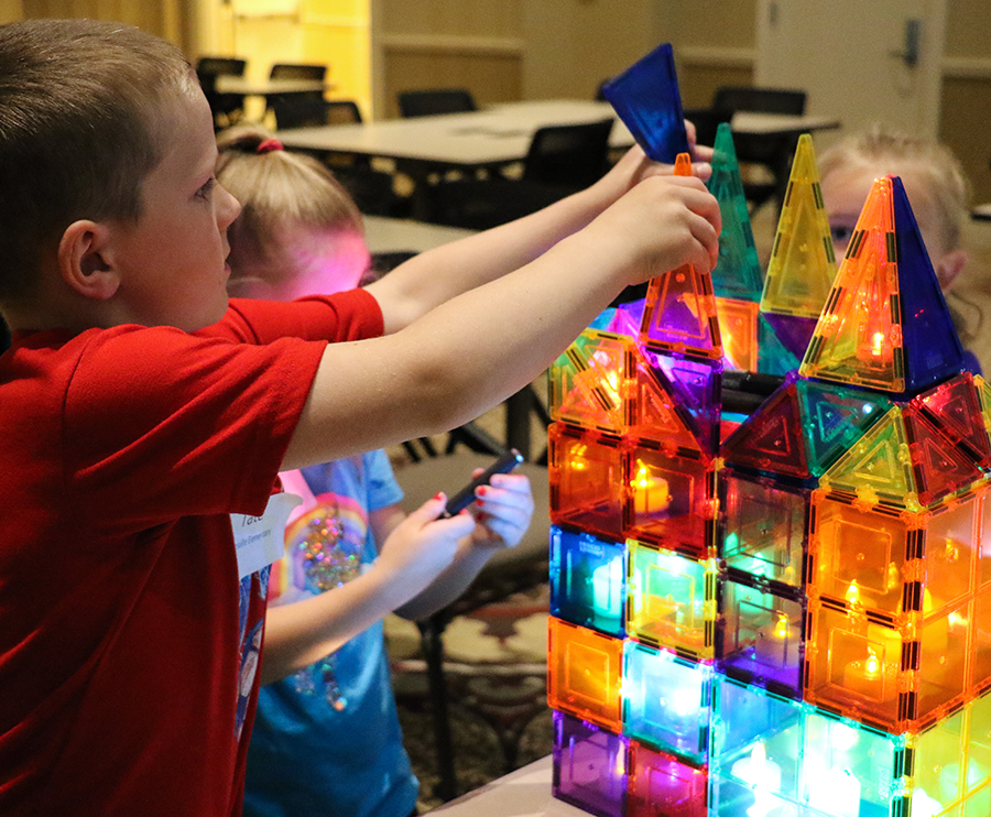 Children building with magnatiles and lights