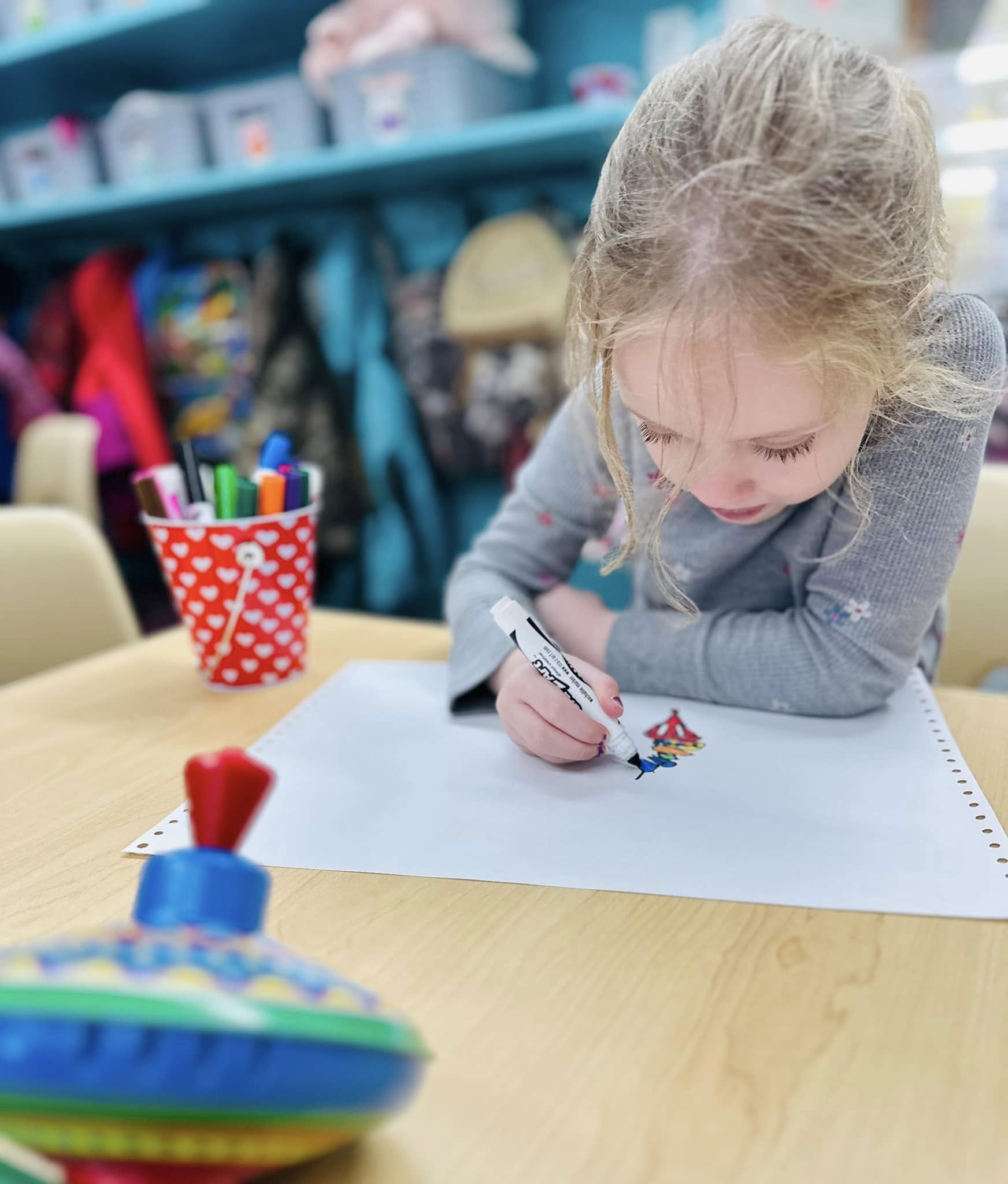 Child drawing a spin top