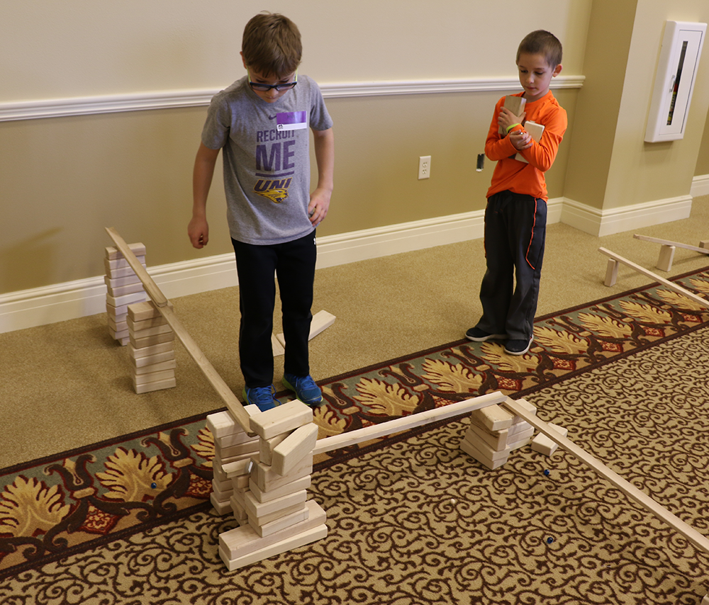 Two boys building ramps