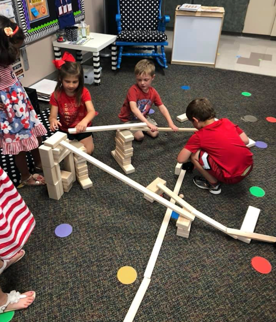 A group of children building ramps and pathways