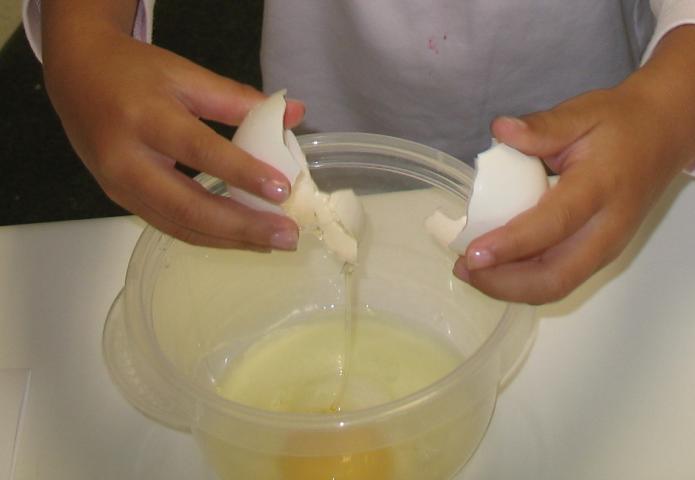 Child cracking an egg