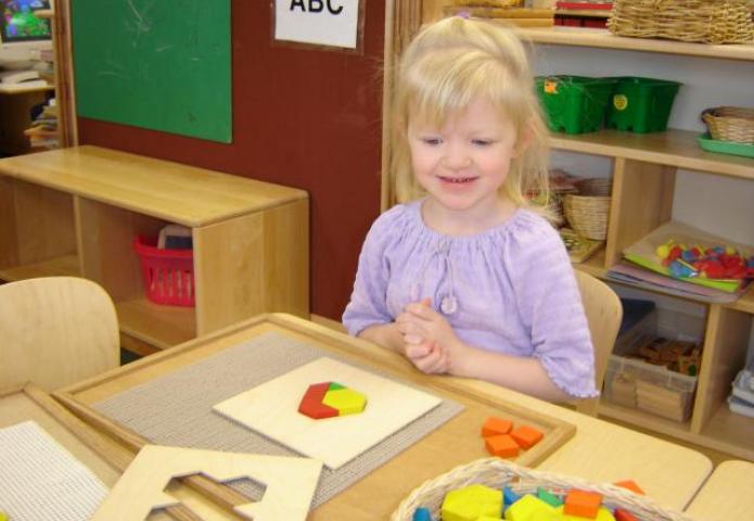 Young child completed her pattern block puzzle