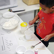 child making pancakes