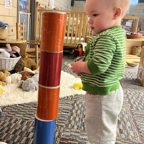 Toddler building with salt boxes