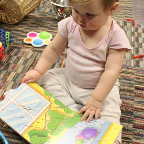 toddler flipping through a book