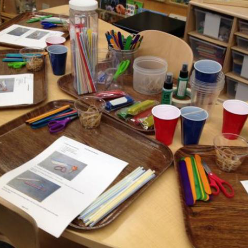 materials set out on a table for making craft harmonicas