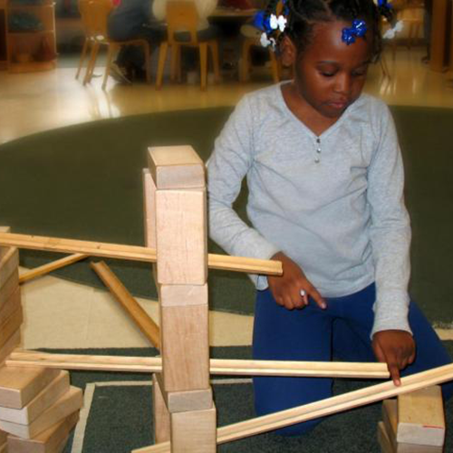 A girl building ramps and pathways