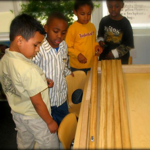 Children making a marble roll along a track