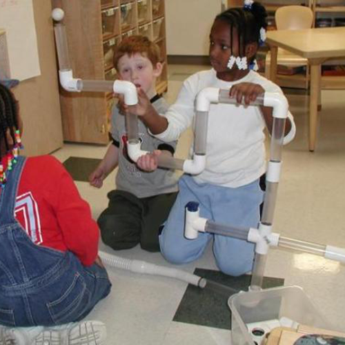 Children using pvc connectors and tubes to make air flow through them